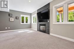 Family Room with Plush Broadloom and Gas Fireplace - 