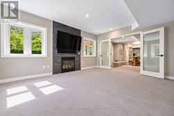 Family Room with Plush Broadloom and Gas Fireplace - 