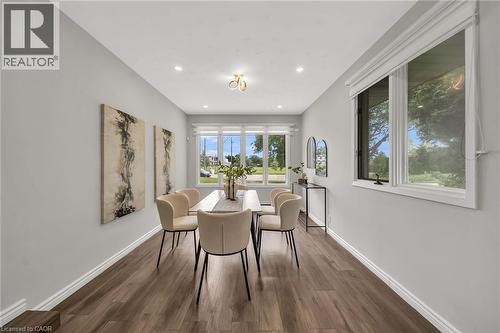 Recessed lighting, wood-finish flooring, multiple windows, and a decorative ceiling light fixture - 284 Cedar Crescent, Cambridge, ON - Indoor Photo Showing Dining Room