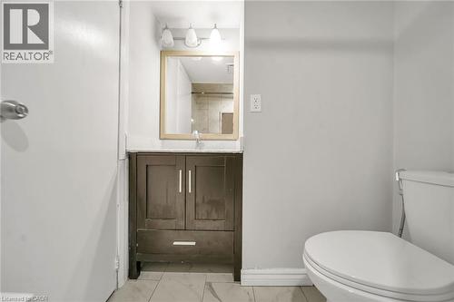 Dark wood-finish vanity with a white countertop - 284 Cedar Crescent, Cambridge, ON - Indoor Photo Showing Bathroom