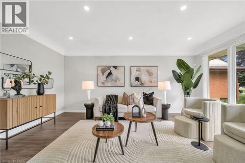 Bright living room featuring recessed ceiling lighting, wide-plank wood-finish flooring, and a neutral color palette - 284 Cedar Crescent, Cambridge, ON - Indoor Photo Showing Living Room