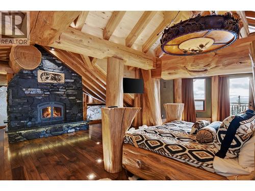 525 Feathertop Way, Big White, BC - Indoor Photo Showing Bedroom With Fireplace