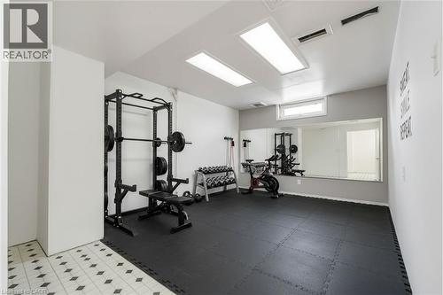 Dedicated fitness space featuring resilient black interlocking floor mats - 1259 Ernest Avenue, London, ON - Indoor Photo Showing Gym Room