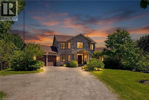 Stone-clad exterior, two-car garage, established landscaping, paved driveway, and covered entry - 5779 Third Line, Guelph/Eramosa, ON - Outdoor