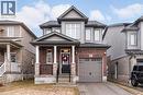 Craftsman house featuring asphalt driveway, a porch, and brick siding - 239 Cranbrook Street, Kitchener, ON  - Outdoor With Facade 