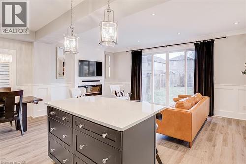 Kitchen featuring open floor plan, a wainscoted wall, a decorative wall, a kitchen island, and a kitchen breakfast bar - 239 Cranbrook Street, Kitchener, ON - Indoor