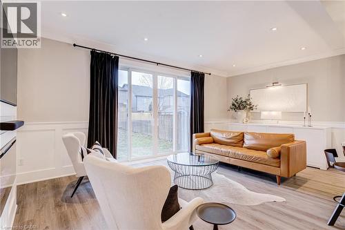 Living room with a wainscoted wall, ornamental molding, recessed lighting, a decorative wall, and light wood finished floors - 239 Cranbrook Street, Kitchener, ON - Indoor Photo Showing Living Room