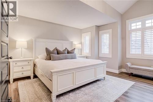 Bedroom with multiple windows, vaulted ceiling, and light wood finished floors - 239 Cranbrook Street, Kitchener, ON - Indoor Photo Showing Bedroom