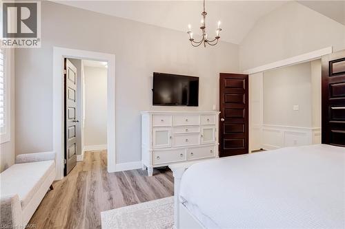 Bedroom featuring a chandelier, light wood-style flooring, and lofted ceiling - 239 Cranbrook Street, Kitchener, ON - Indoor Photo Showing Bedroom