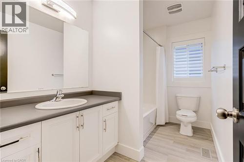 Bathroom with vanity, light wood finished floors, and shower / bath combo with shower curtain - 239 Cranbrook Street, Kitchener, ON - Indoor Photo Showing Bathroom