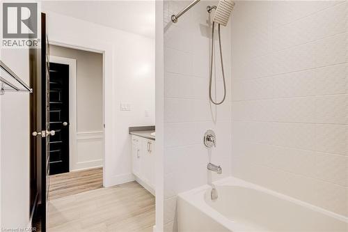 Bathroom featuring vanity, shower / washtub combination, and light wood-style floors - 239 Cranbrook Street, Kitchener, ON - Indoor Photo Showing Bathroom