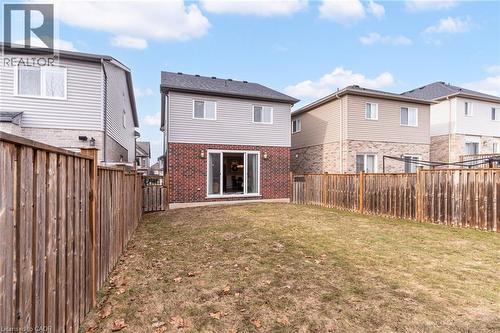 Rear view of house featuring a fenced backyard, brick siding, and a residential view - 239 Cranbrook Street, Kitchener, ON - Outdoor With Exterior