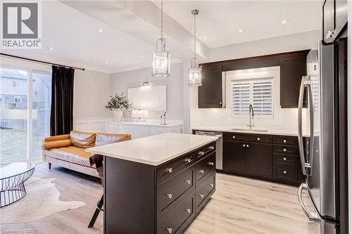 Kitchen featuring stainless steel appliances, a breakfast bar, open floor plan, a center island, and dark wood finish cabinets - 239 Cranbrook Street, Kitchener, ON - Indoor Photo Showing Kitchen With Upgraded Kitchen