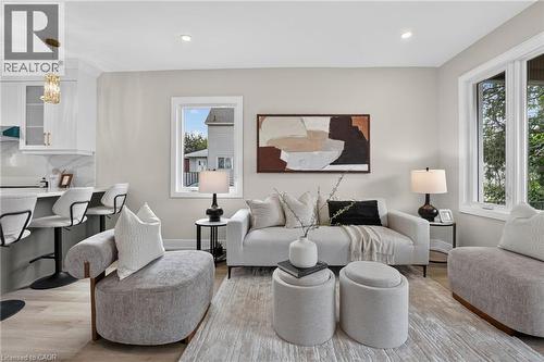 Recessed lighting, wood-finish flooring, white cabinetry, light-colored walls, and ample natural light from multiple windows - 174 London Street N, Hamilton, ON - Indoor Photo Showing Kitchen With Stainless Steel Kitchen With Upgraded Kitchen