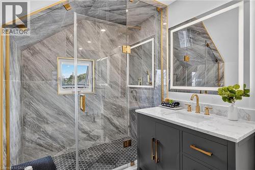 Glass-enclosed shower with a hexagon tile floor and a window - 174 London Street N, Hamilton, ON -  Photo Showing Bathroom