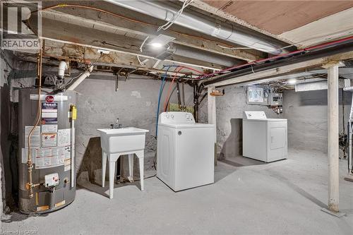 Finished Basement Utility Area featuring multiple large-capacity appliances including a water heater, washer, and dryer - 174 London Street N, Hamilton, ON - Outdoor