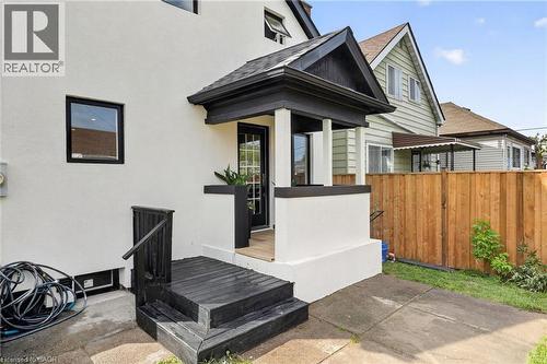 Stucco exterior with black-framed windows - 174 London Street N, Hamilton, ON - Outdoor