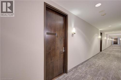 Hallway with wood-finish doors and light-toned walls - 191 King Street S Unit# 607, Waterloo, ON - Indoor Photo Showing Other Room