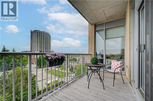 Private balcony featuring a light-colored outdoor rug, a metal railing, and a brick exterior wall - 191 King Street S Unit# 607, Waterloo, ON - Outdoor With Balcony With Exterior