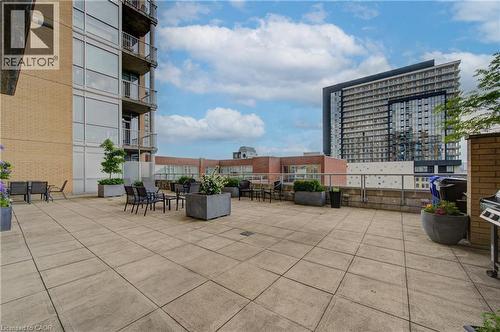 Expansive paver patio with perimeter planters and a low brick wall - 191 King Street S Unit# 607, Waterloo, ON - Outdoor