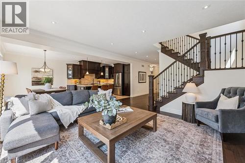 Open-concept living space featuring dark wood-finish flooring. - 828 Copper Ridge Drive, Waterloo, ON - Indoor Photo Showing Living Room