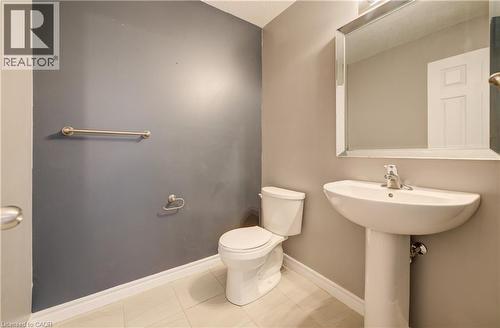Pedestal sink with chrome faucet, complemented by a rectangular framed mirror - 80 Miranda Path, Elmira, ON - Indoor Photo Showing Bathroom