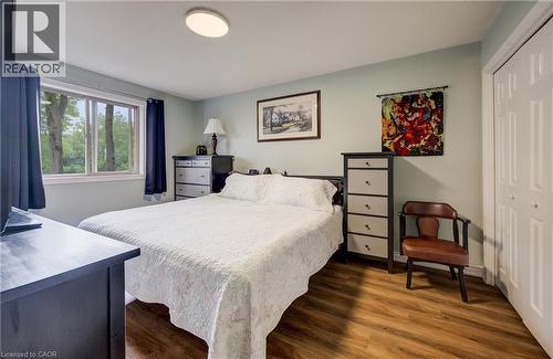 Wood-finish flooring, flush mount ceiling light, and window with natural light - 16 Steed Court, Brantford, ON 
