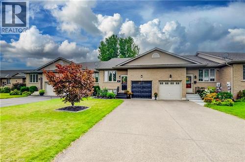 Brick facade with an attached single-car garage - 16 Steed Court, Brantford, ON 