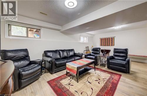 Recessed windows, wood-finish flooring, white walls, and ceiling-mounted lighting fixtures - 16 Steed Court, Brantford, ON 