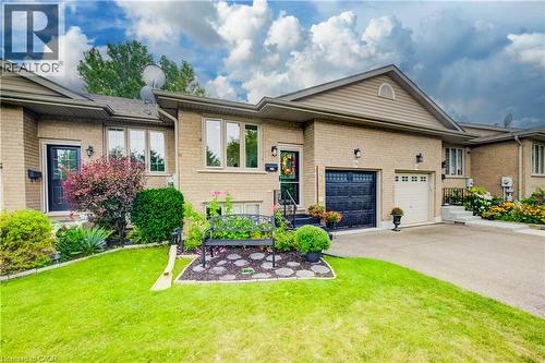 Brick exterior with gabled roofline, and paved driveway - 16 Steed Court, Brantford, ON 
