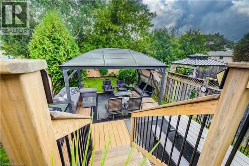 Multi-level wood-finish deck with black metal balusters - 16 Steed Court, Brantford, ON 