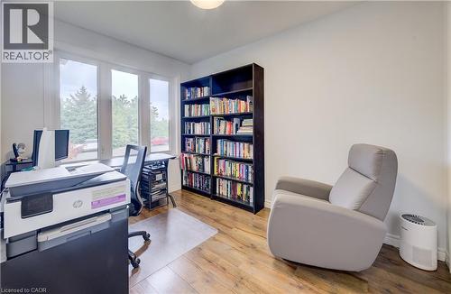 Room with wood-finish flooring, white walls, and built-in shelving - 16 Steed Court, Brantford, ON 