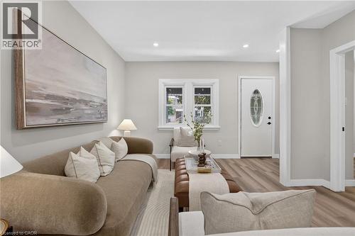 Recessed lighting, wood-finish flooring, white trim, and a white entry door with an oval glass insert - 43 E Brucedale Avenue E, Hamilton, ON 