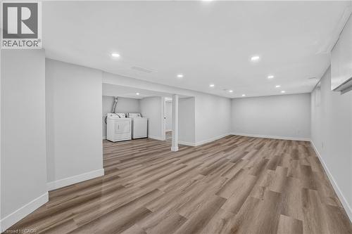 Spacious room featuring wood-finish flooring, recessed lighting, and light-toned wall finishes - 43 E Brucedale Avenue E, Hamilton, ON 