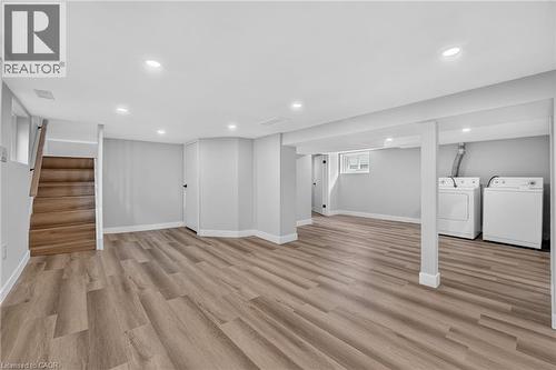 Spacious room with wood-finish flooring, recessed lighting, and a neutral color palette - 43 E Brucedale Avenue E, Hamilton, ON 
