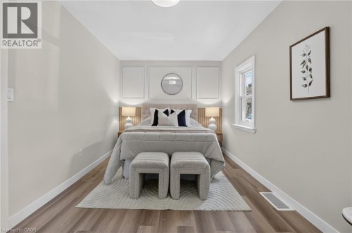 Wood-finish flooring, white trim, recessed ceiling light, and a single window - 43 Brucedale Avenue E, Hamilton, ON 