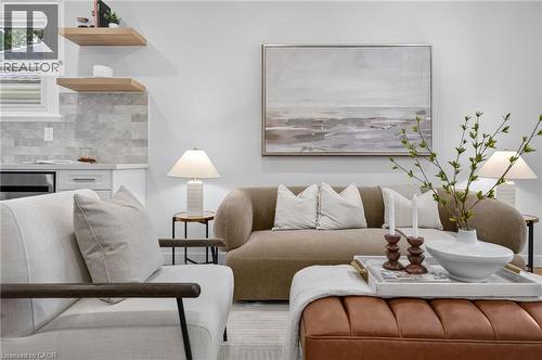 Bright interior with wood-finish floating shelves, white cabinetry, and a subway tile backsplash - 43 E Brucedale Avenue E, Hamilton, ON 