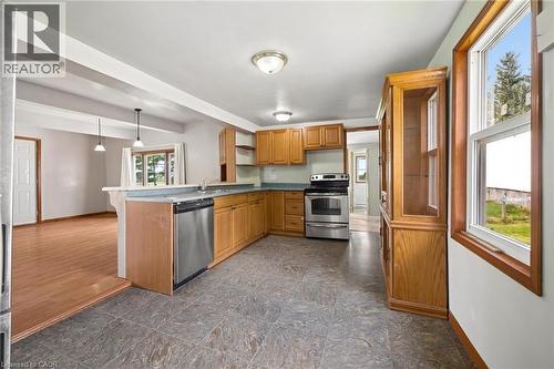 Kitchen featuring wood-finish cabinetry, stainless steel appliances, and tile flooring - 5480 Line 42 Line, Mitchell, ON 