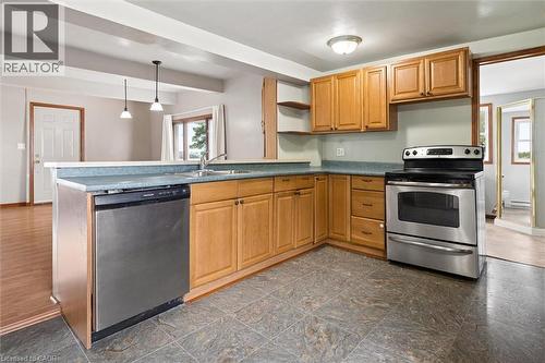 Kitchen featuring wood cabinetry, stainless steel appliances, a built-in dishwasher, and tile flooring - 5480 Line 42 Line, Mitchell, ON 