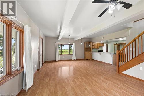 Expansive room featuring wood-finish flooring, exposed ceiling beams, and multiple windows - 5480 Line 42 Line, Mitchell, ON 