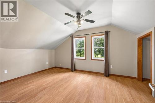 Vaulted ceiling with a ceiling fan, two windows, wood-finish flooring, and light-toned walls - 5480 Line 42 Line, Mitchell, ON 