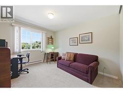 Carpeted 2nd bedroom with a window facing mountain views - 