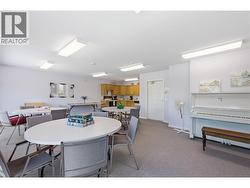 Party Room: Full kitchen, seating area & piano for resident gatherings - 2nd floor - 