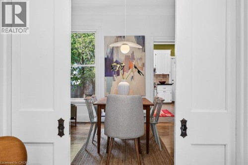 Recessed panel sliding doors reveal wood-finish flooring - 16 Bruce Street, Hamilton, ON 