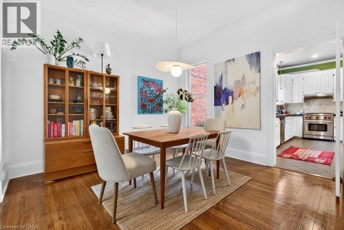 Hardwood flooring throughout, recessed lighting, white trim and baseboards, and a contemporary pendant light fixture - 16 Bruce Street, Hamilton, ON 