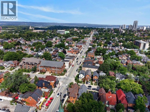 Aerial perspective showcasing a dense urban setting with a prominent thoroughfare and a variety of architectural styles - 16 Bruce Street, Hamilton, ON 