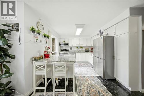 White cabinetry with extensive storage, stainless steel appliances, and a light-toned countertop - 384 Limeridge Road E Unit# 16, Hamilton, ON 