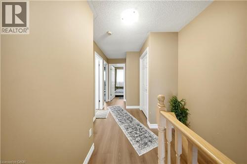 Hardwood-finish flooring, light-toned walls, and wood railings - 384 Limeridge Road E Unit# 16, Hamilton, ON 