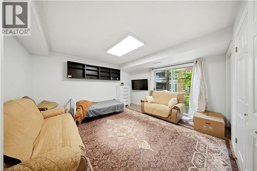 Recessed ceiling light fixture, built-in shelving, sliding glass door, and white paneled doors - 384 Limeridge Road E Unit# 16, Hamilton, ON 