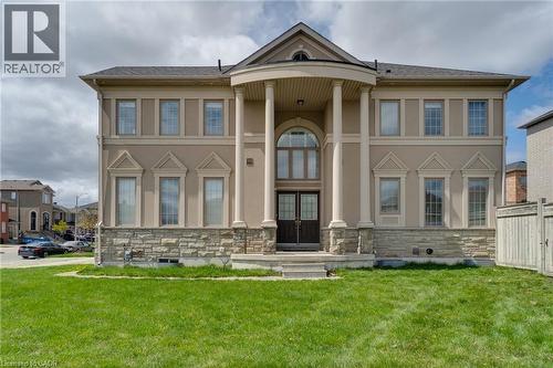 Stucco exterior with stone veneer accents, grand columned portico, double entry doors, and arched transom window - 2 Hawstone Road, Vellore, ON 